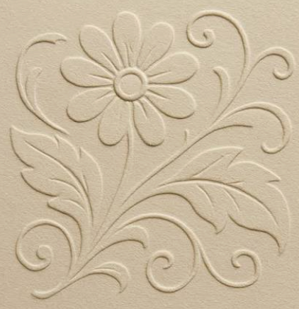 An embossed floral design raised above the surface of cream-colored paper.
